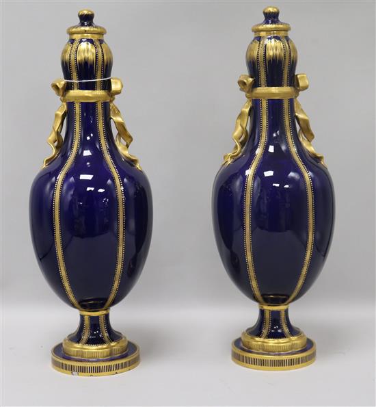 A pair of French blue and gilt porcelain vases height 30cm